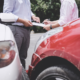 Two individuals discussing paperwork after a car accident